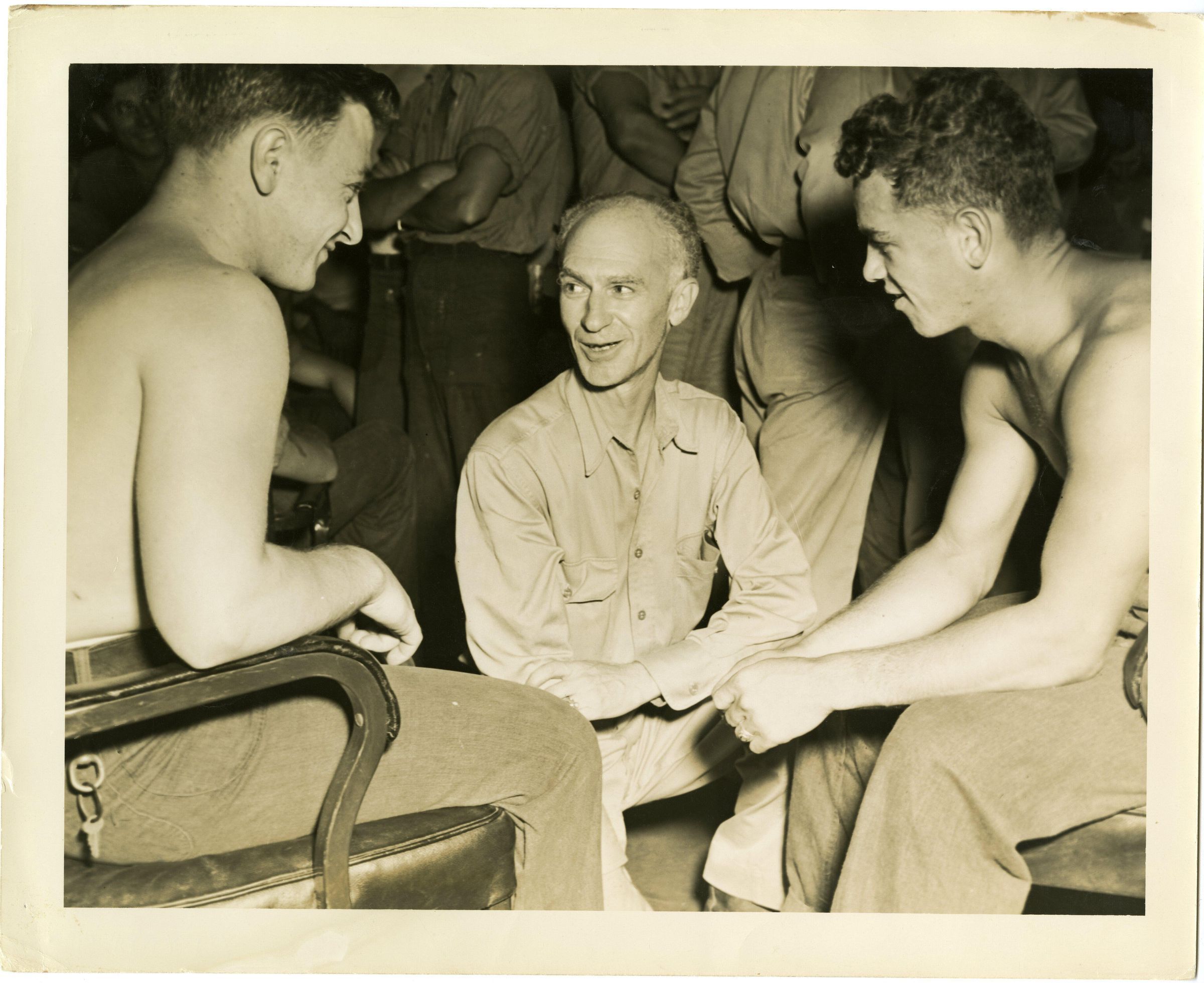 Primary Image of Sailors Talking with Ernie Pyle