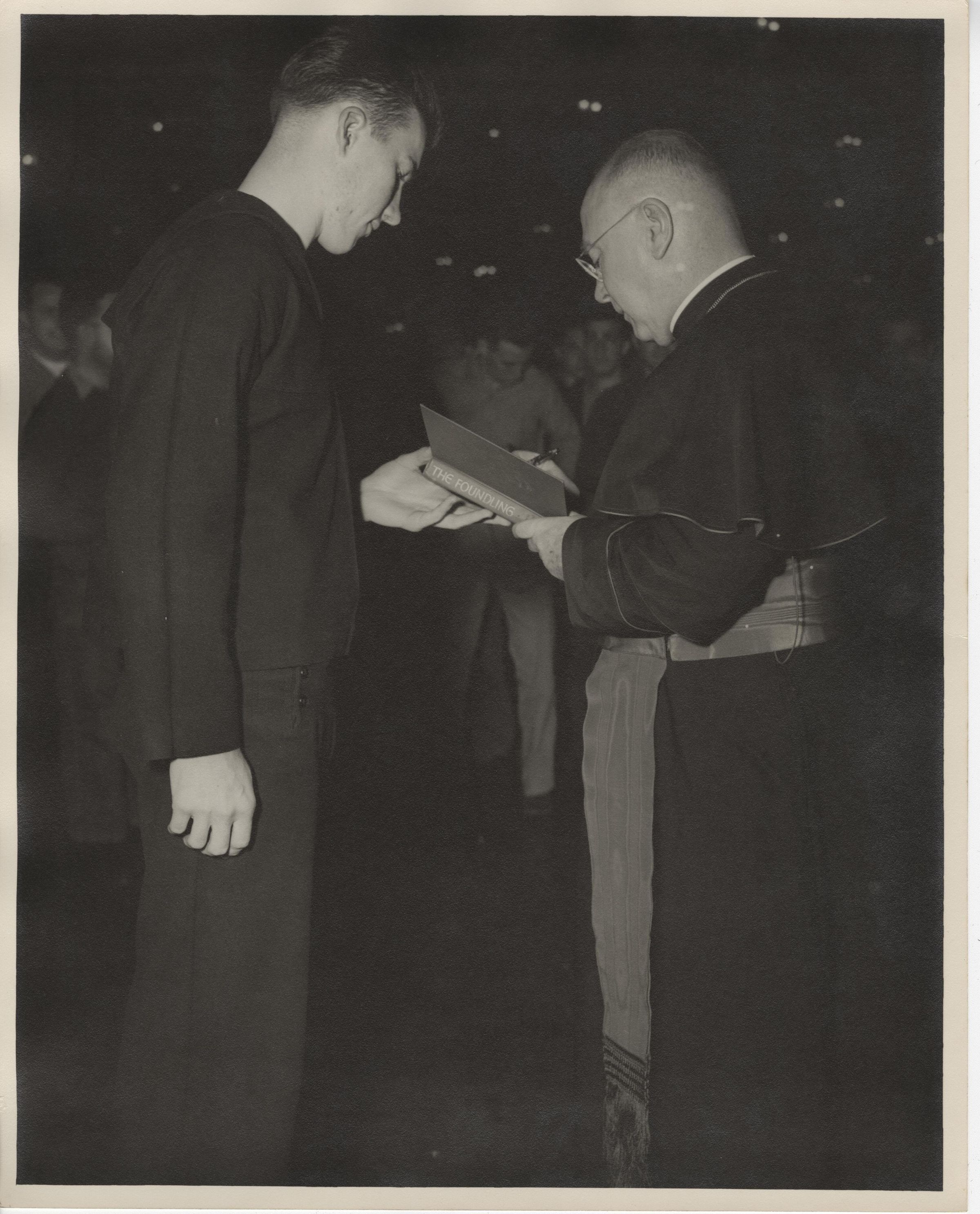 Primary Image of Cardinal Francis Spellman Autographing a Copy of his Book for a Sailor