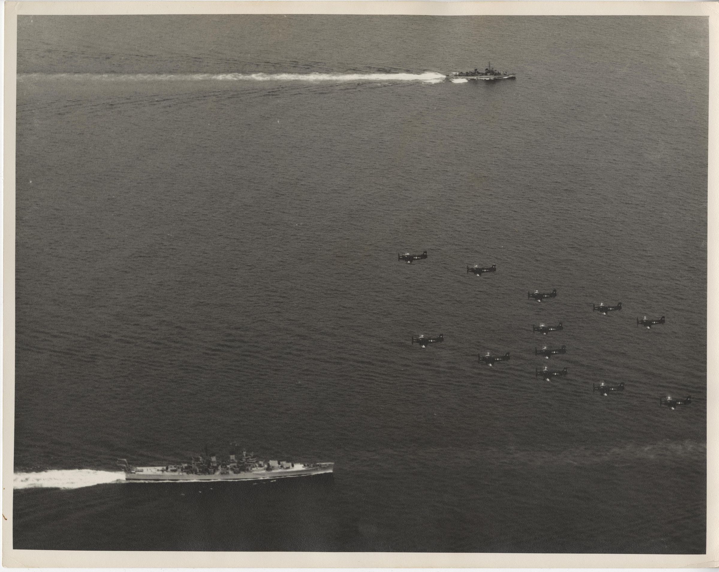 Primary Image of Skyraiders Flying Over Part of a Carrier Task Force