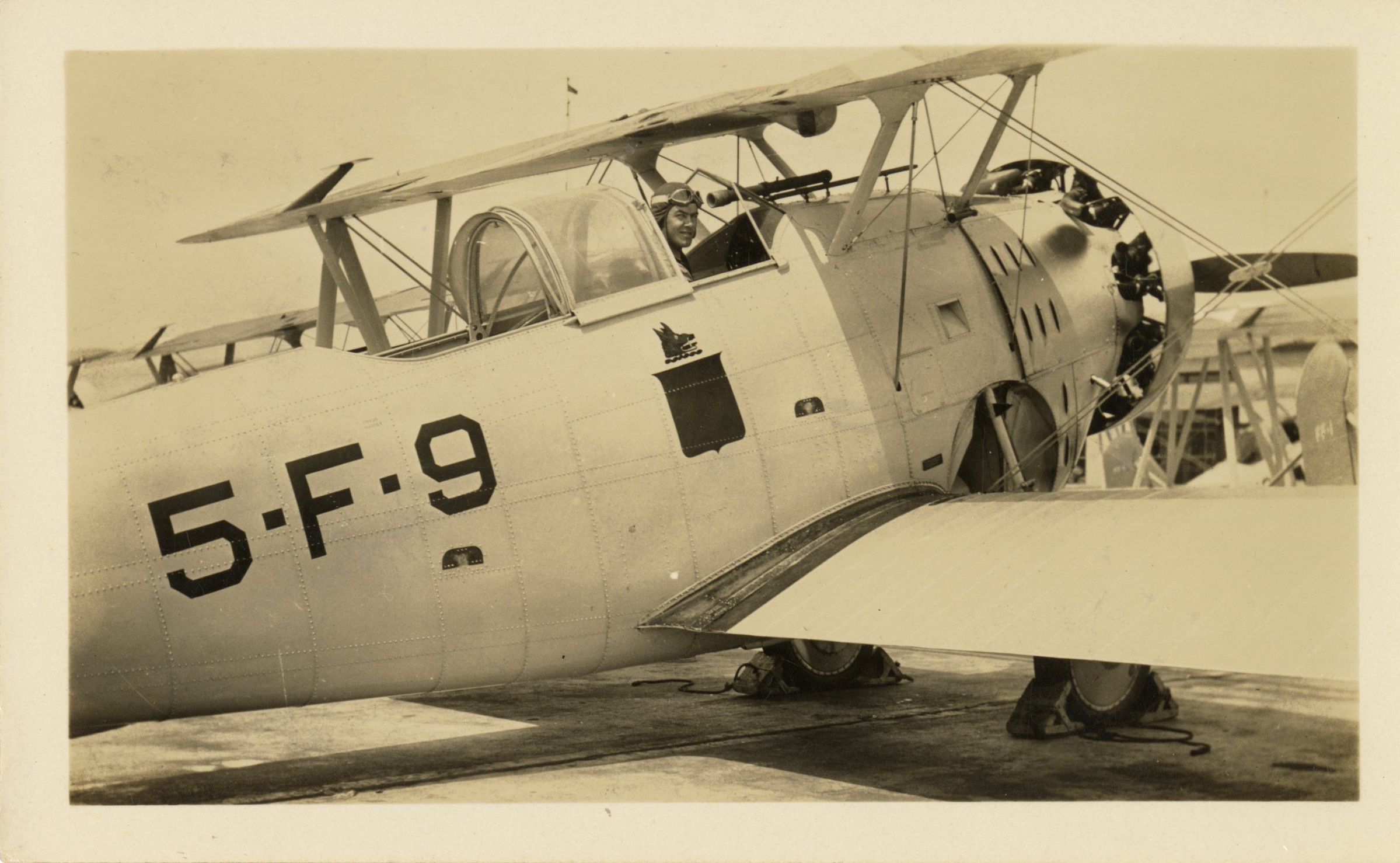 Primary Image of James H. Flatley Jr. in the Cockpit of a Grumman FF-1 Biplane
