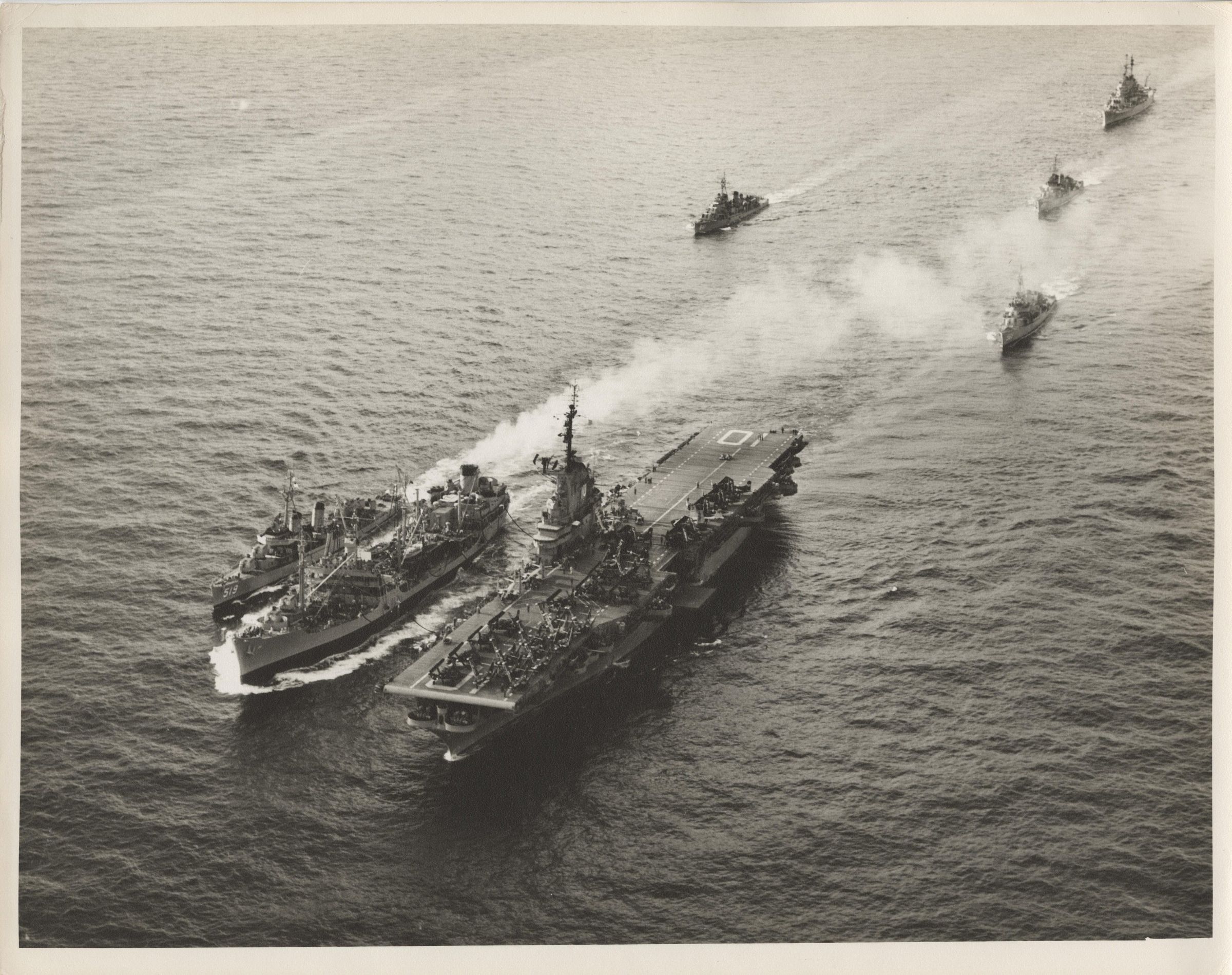 Primary Image of USS Yorktown (CVA-10) and USS Daly (DD-519) Being Refueled by a Supply Ship