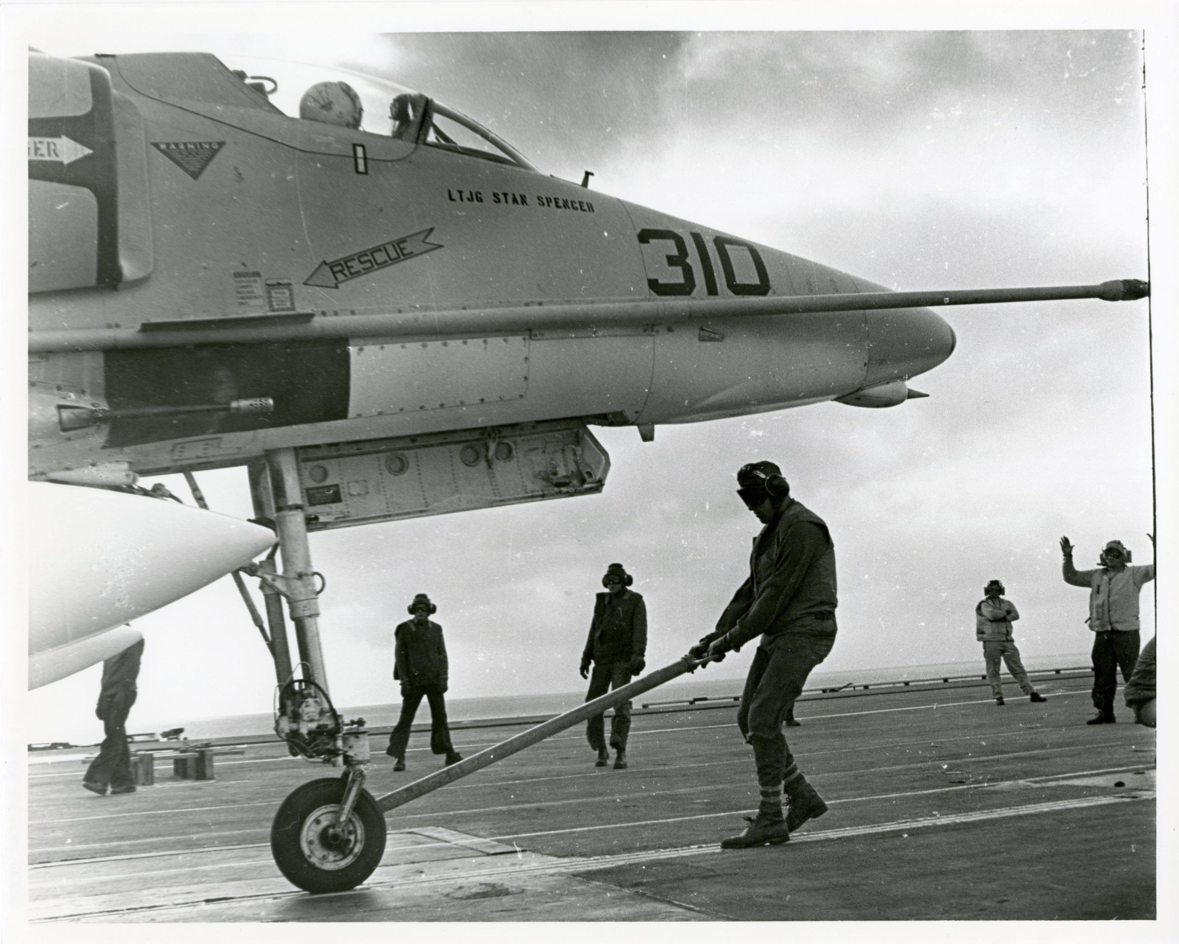 Primary Image of A-4 Skyhawk Being Moved Across the Flightdeck