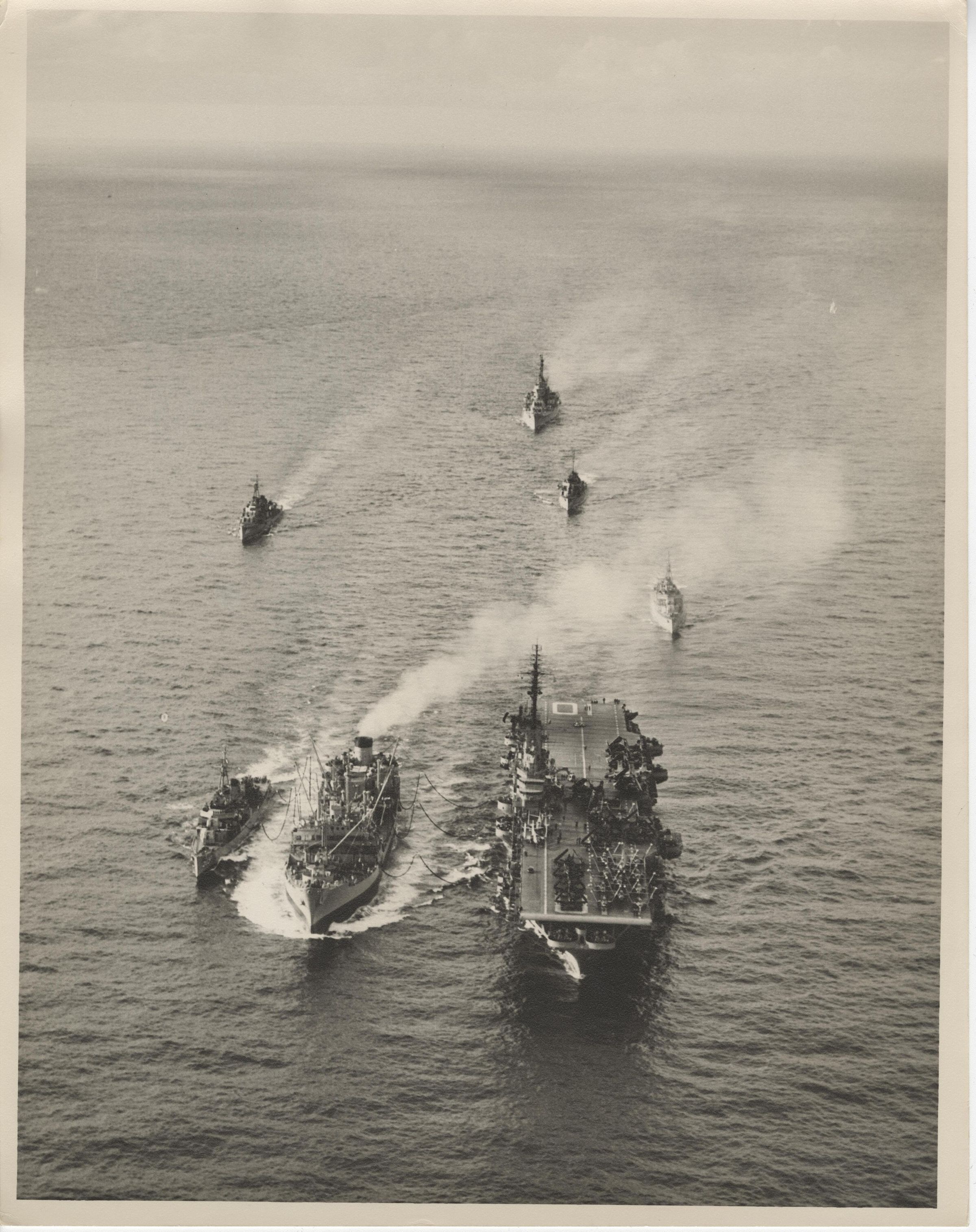 Primary Image of USS Yorktown (CVA-10) and USS Daly (DD-519) Being Refueled by a Supply Ship