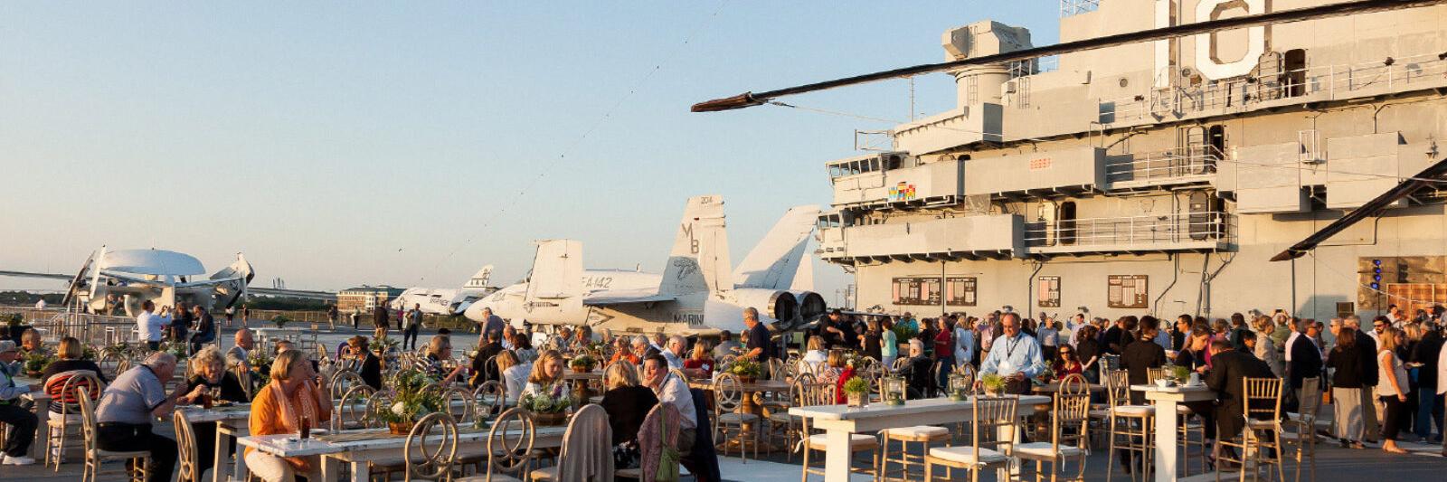 People mingling on the flight deck of the USS Yorktown