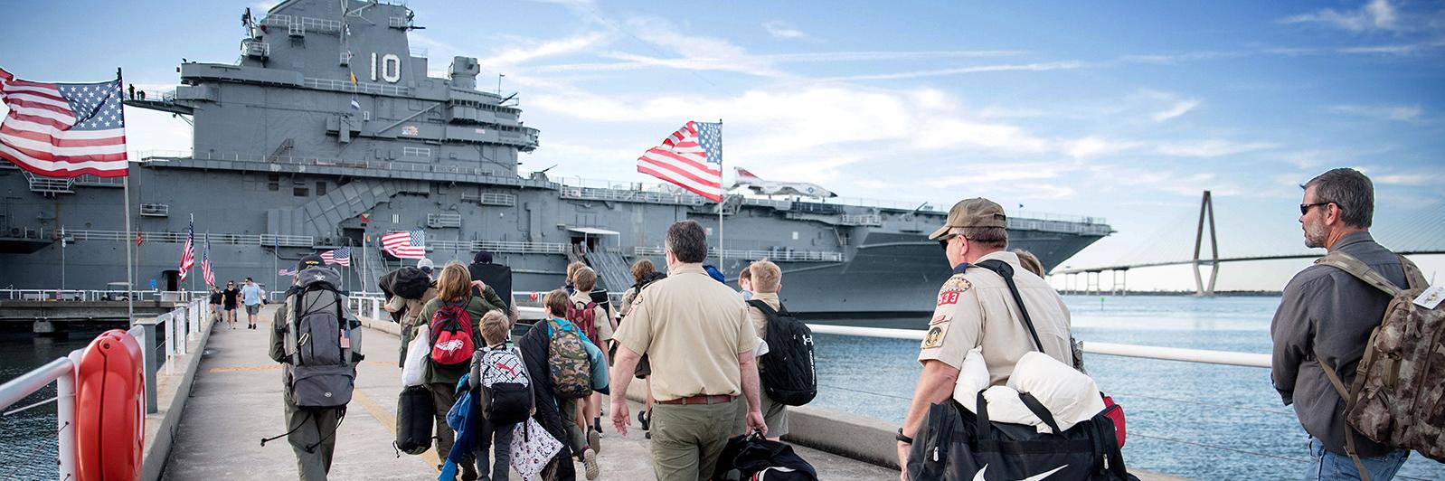 People walking up to Patriots Point with overnight bags