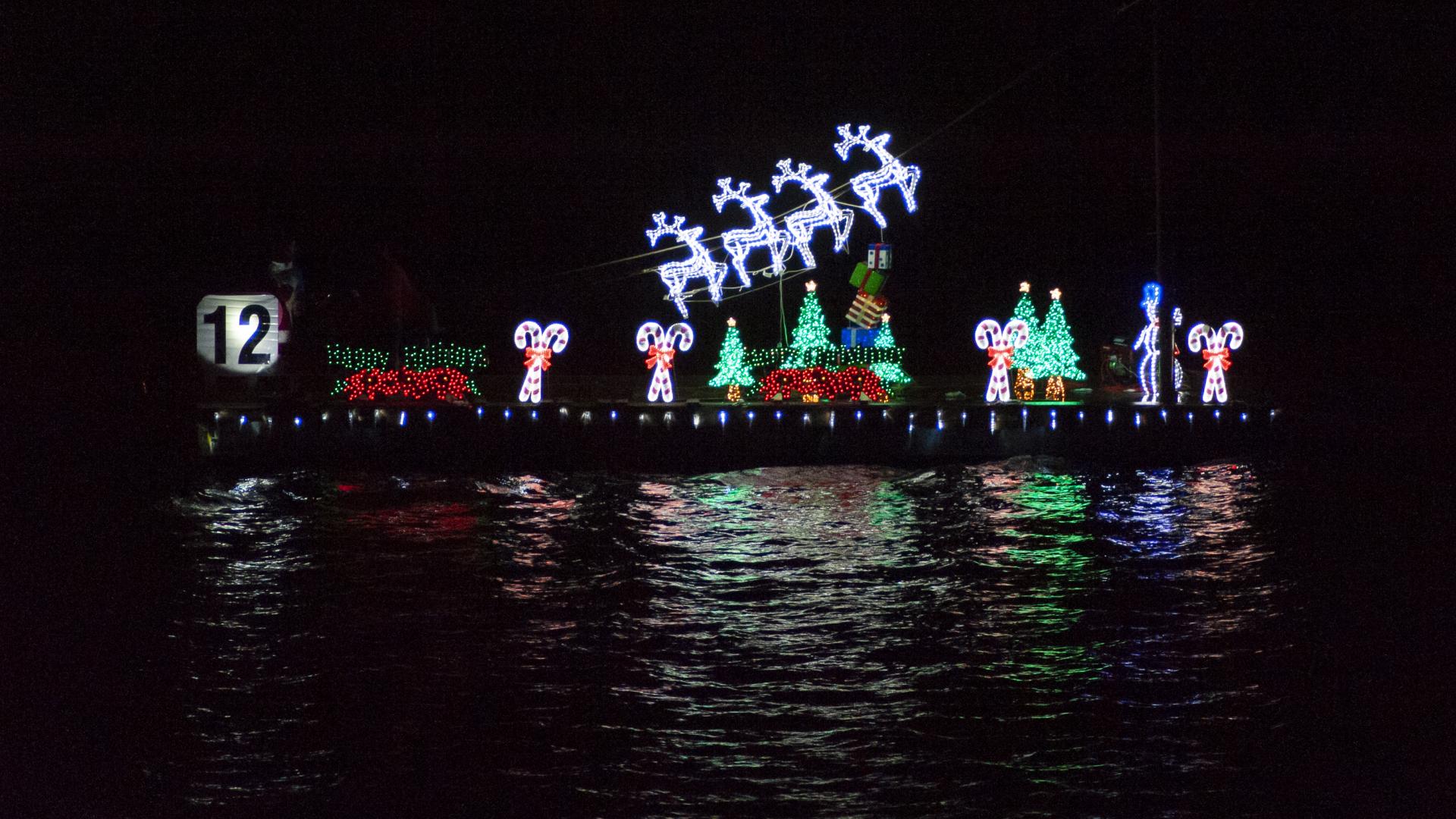 Lights on the Harbor: A Boat Parade Watch Party showing a boat with lit up holiday decorations