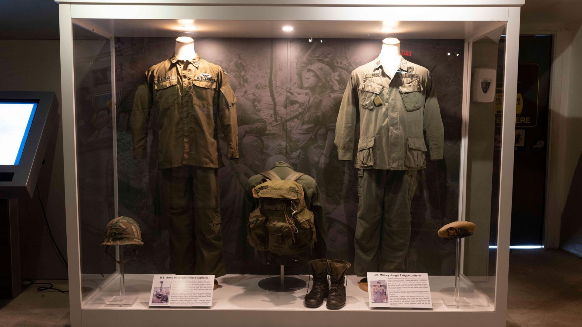 2 military uniforms behind glass in a museum