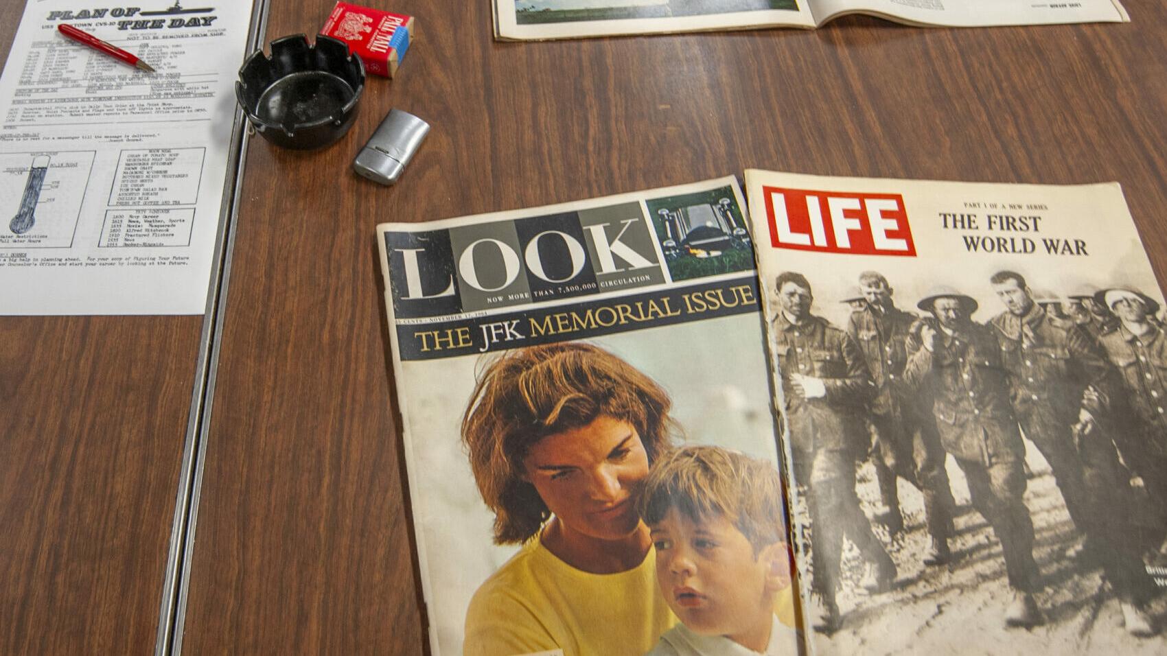 Older magazines shown on the table, Look the JFK Memorial Issues and Life: The First World War issue