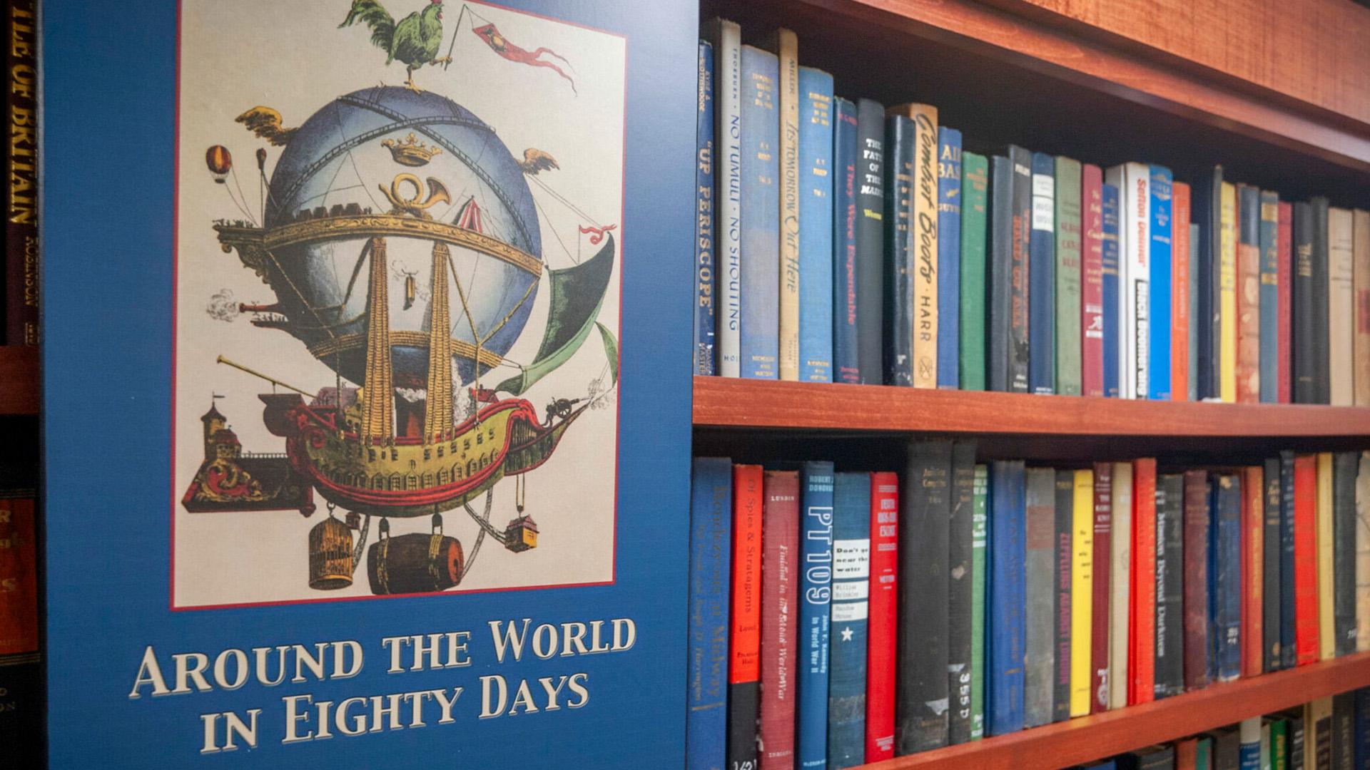 Poster beside a bookcase reads: Around the World in Eighty Days