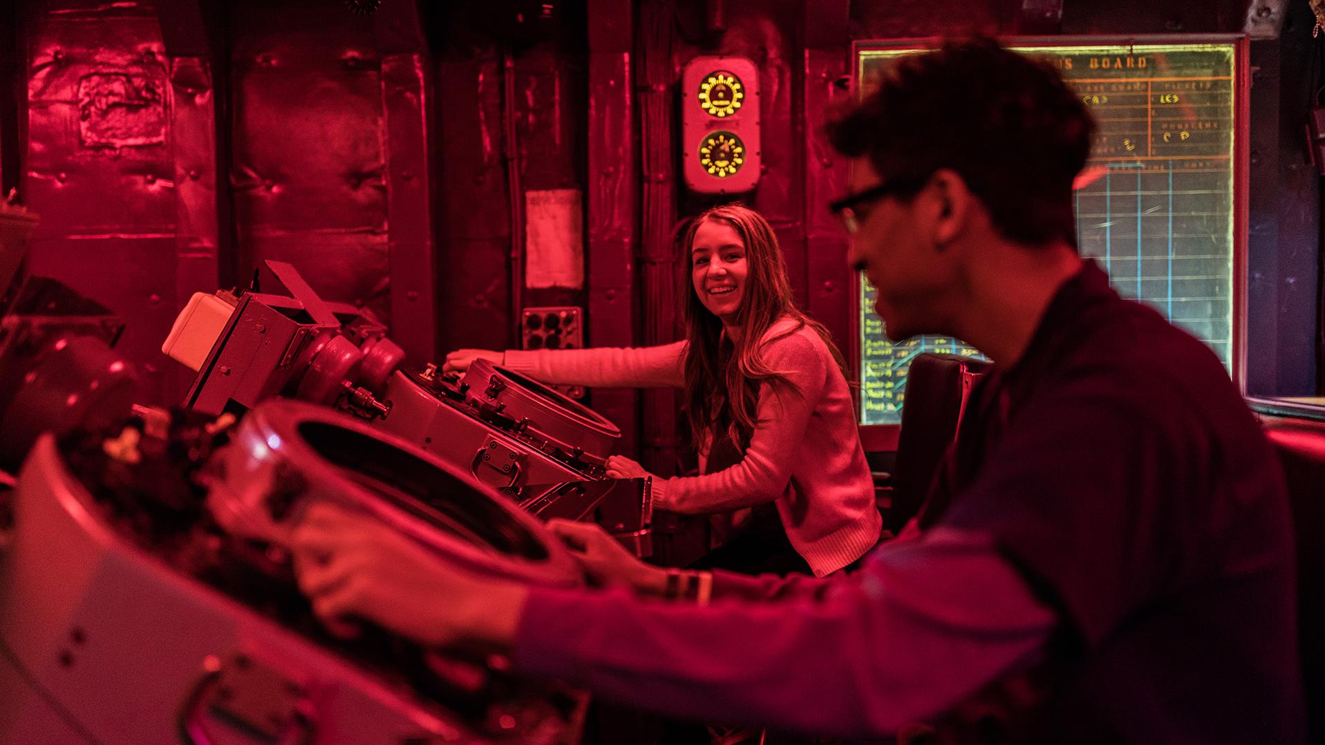 A girl and boy in the Combat Information Center