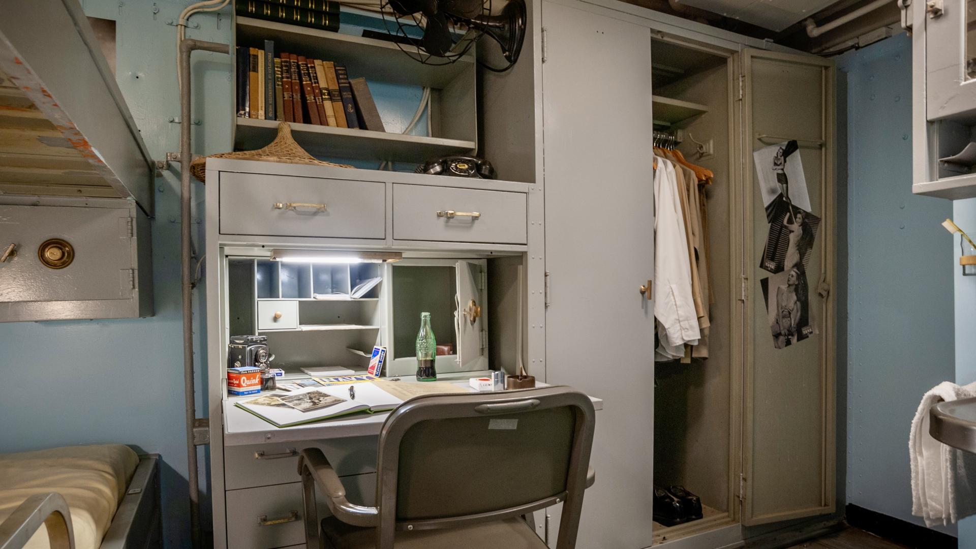 Officer stateroom with bunk, desk, and wardrobe