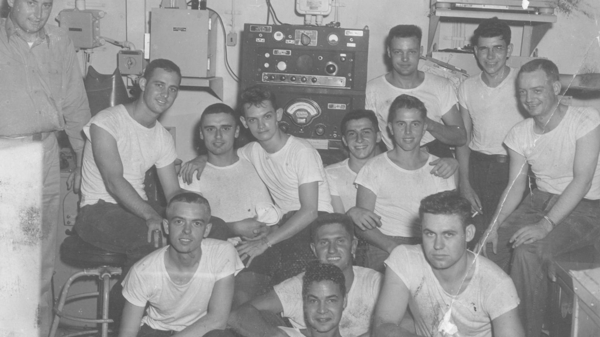 Black and white photograph of the aerology crew in the weather office aboard USS YORKTOWN during Korea.