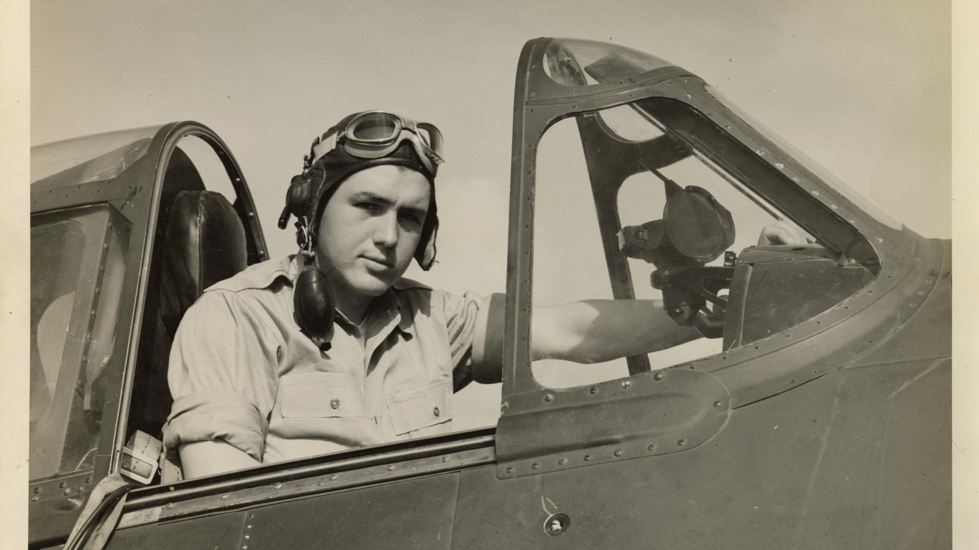 Image of Smokey Stover sitting in the cockpit of an aircraft.