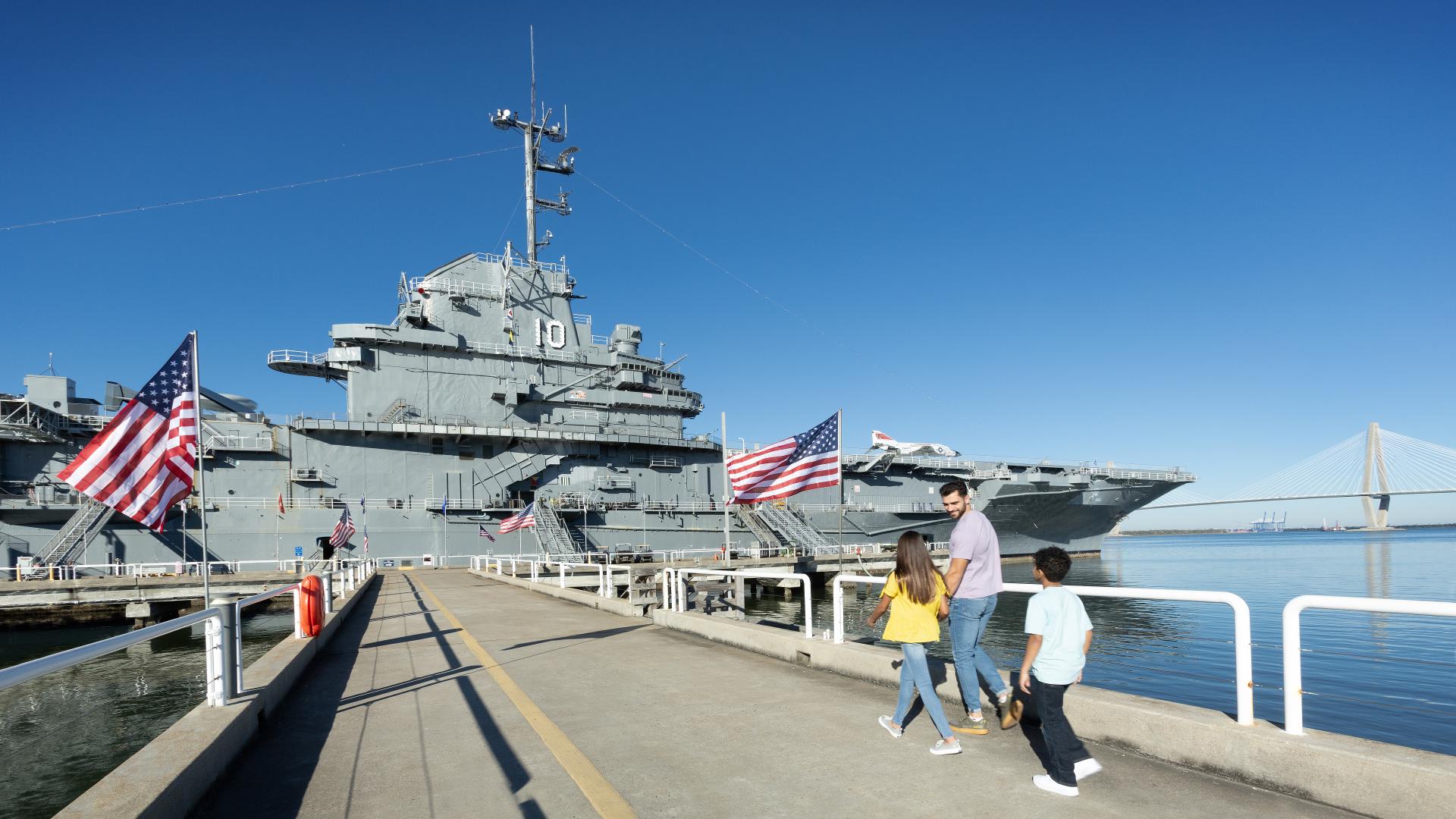 Family walking down the pier to the Yorktown