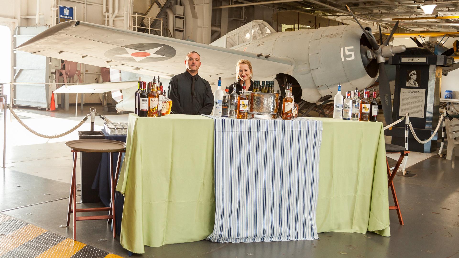 Vendors for an event set up in the hangar bay of the USS Yorktown at Patriots Point.