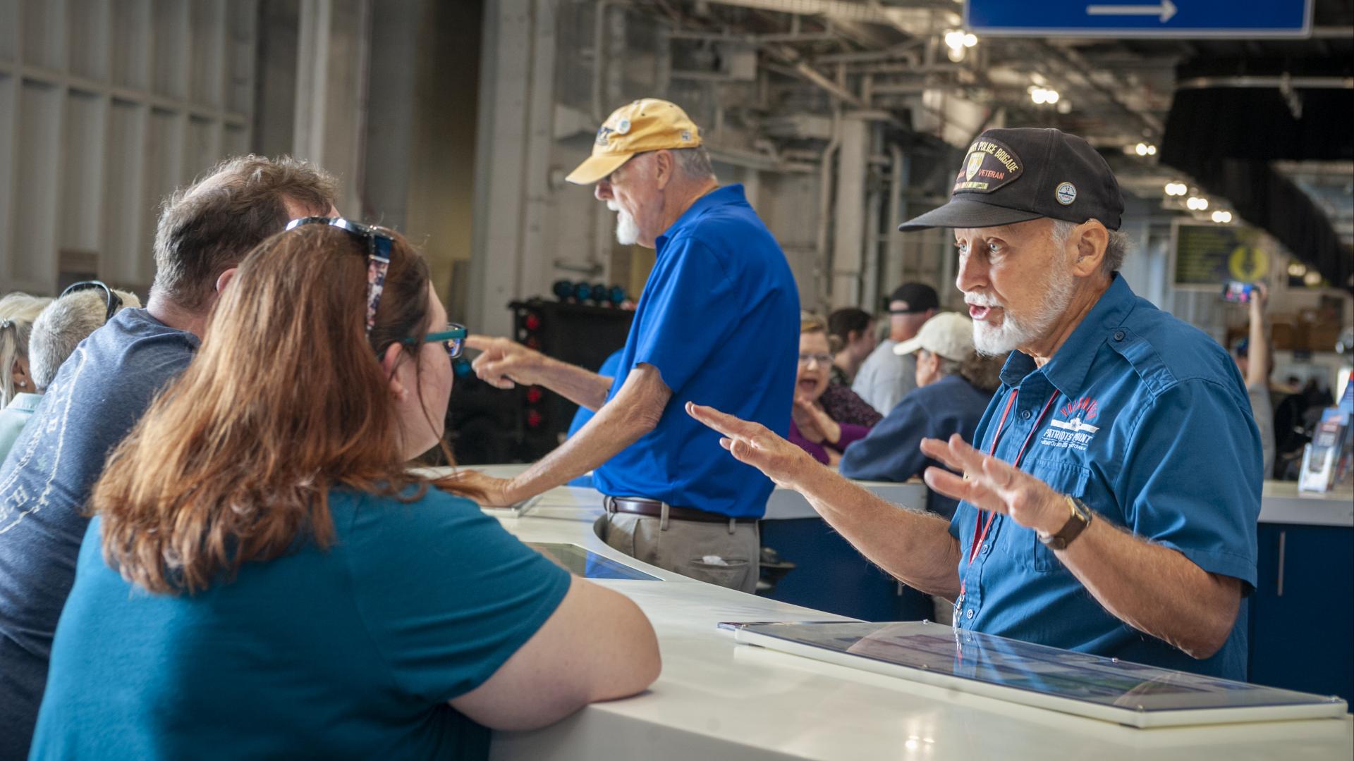 Volunteers speak to guests and the Information Desk at Patriots Point. 