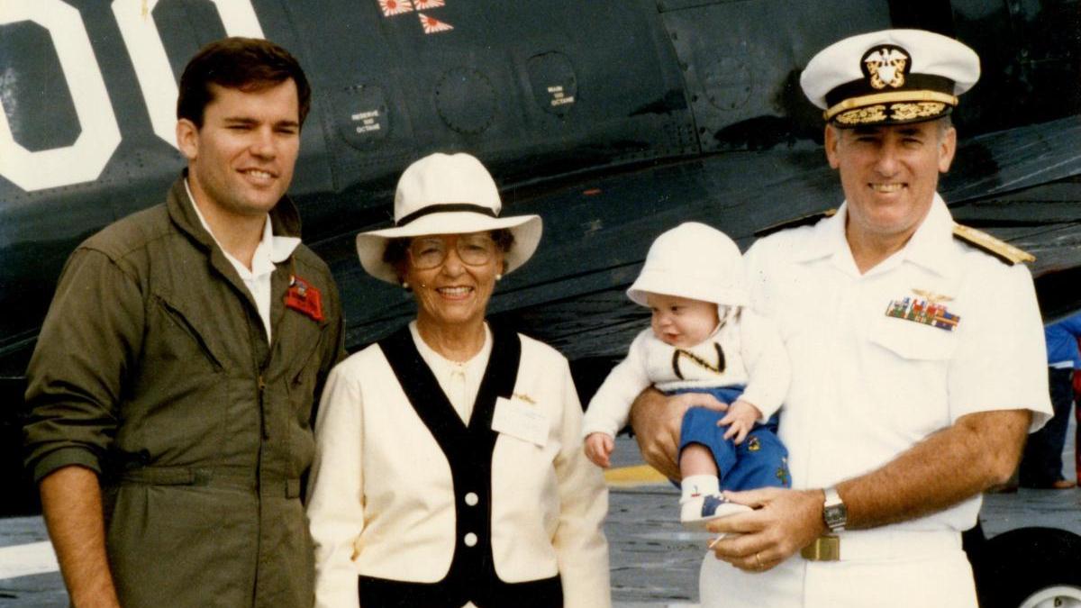 Admiral Flatley and his family posed in front of an aircraft