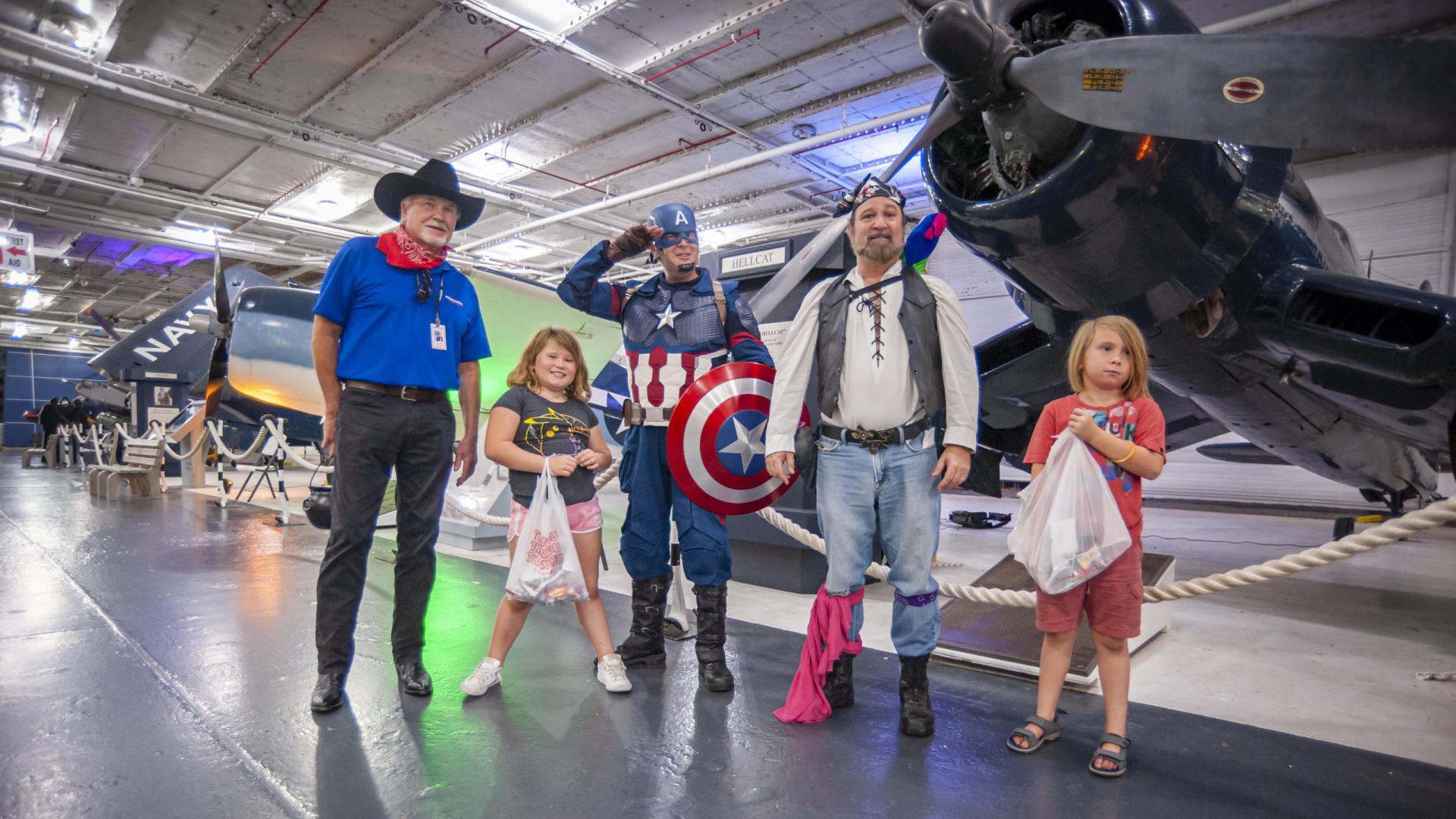 Group dressed up for Halloween. Cowboy, Captain America, Pirate to name a few.