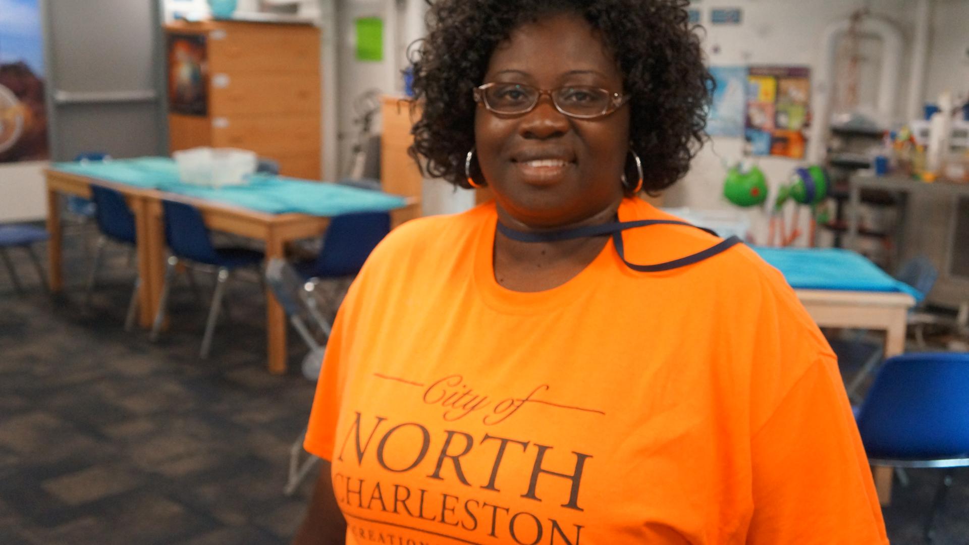 Black female with an orange City of North Charleston teeshirt 