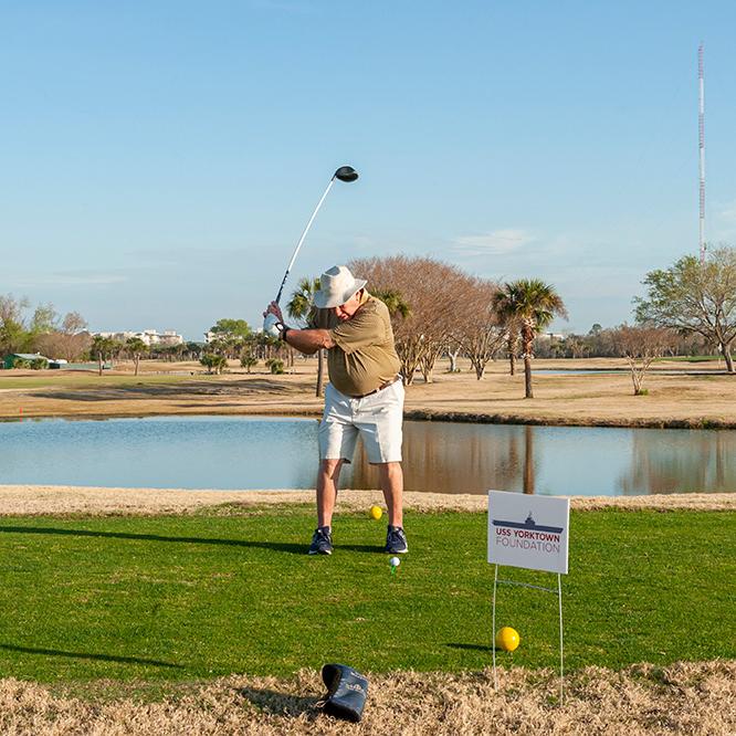 A player swinging a golf club at the golf tournament