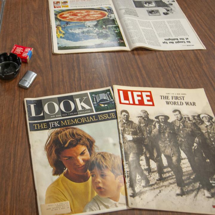 Older magazines shown on the table, Look the JFK Memorial Issues and Life: The First World War issue