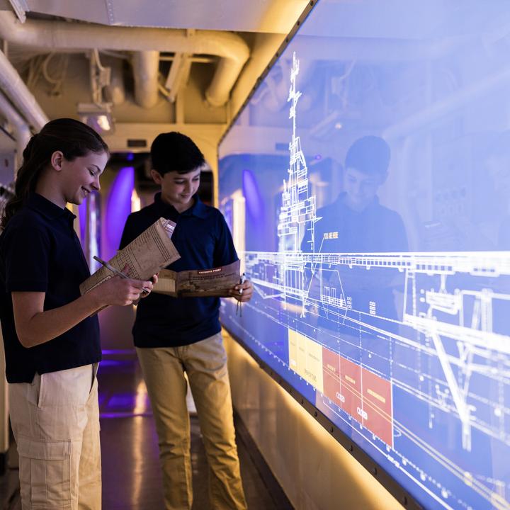 A boy and a girl in the Engine Room Experience