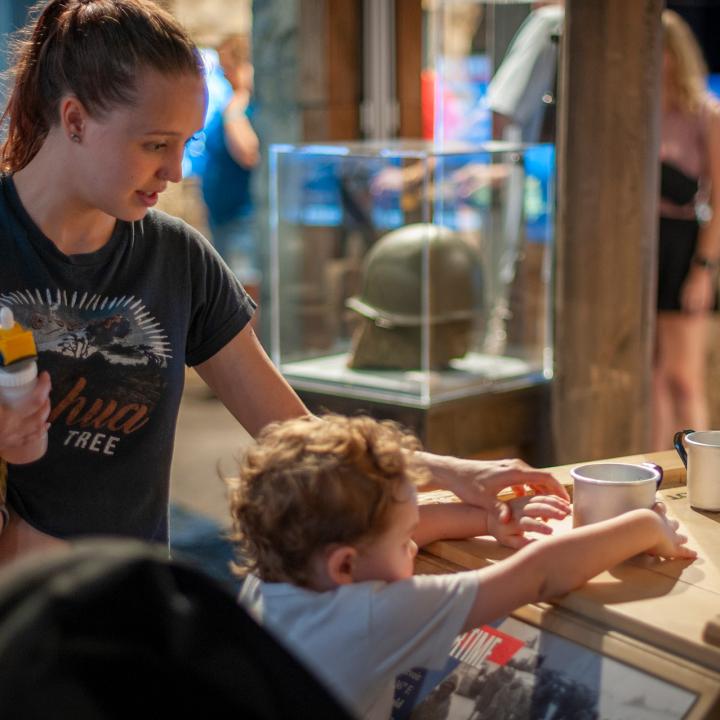 A mother with two small children inside the Medal of Honor Museum