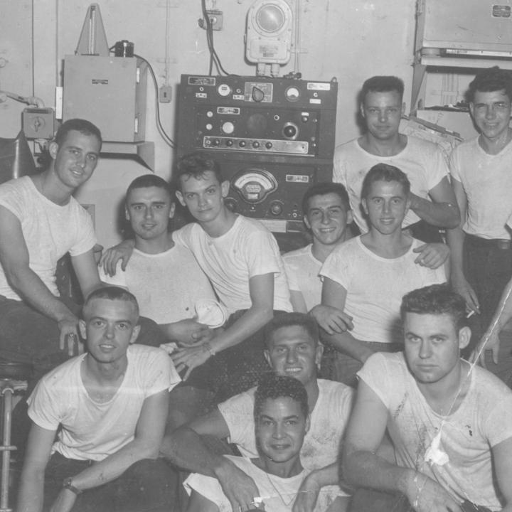 Black and white photograph of the aerology crew in the weather office aboard USS YORKTOWN during Korea.