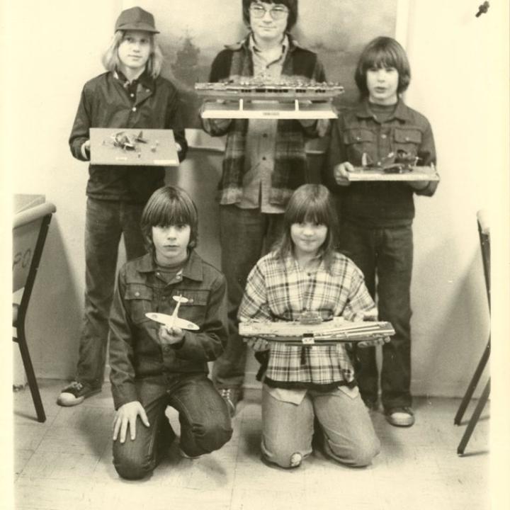 This photograph shows children taking part in a model building contest in the CPO lounge on opening day ceremonies aboard the USS Yorktown, January 3, 1976.