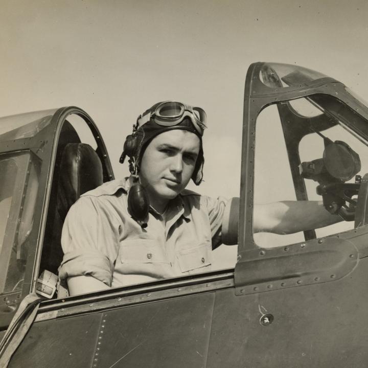 Image of Smokey Stover sitting in the cockpit of an aircraft.