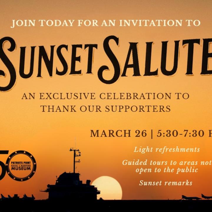 Aircraft carrier with sun setting in the background.