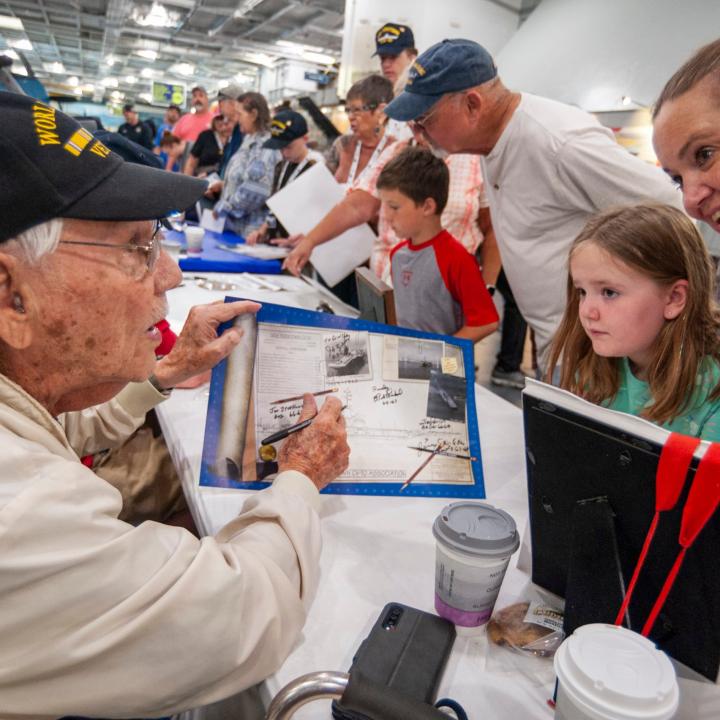 A Veteran speaking with some visitors