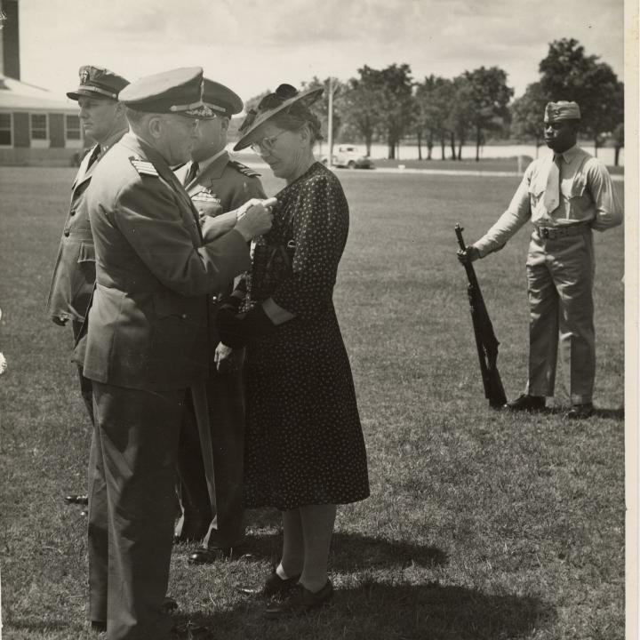 Primary Image of Stella Stover Receiving a Medal Awarded Posthumously for her Son.