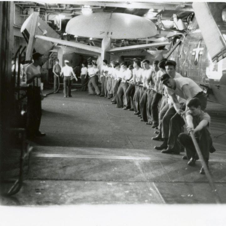 Primary Image of Crewmembers Working in the Hanger Deck