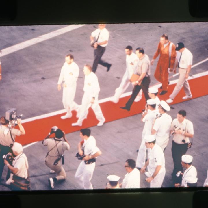 Primary Image of Apollo 8 Astronauts Walk Across the Flightdeck