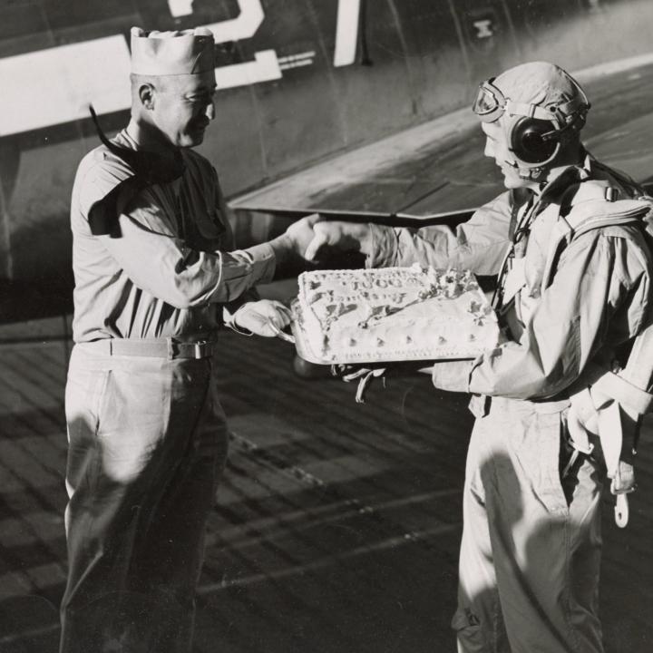 Primary Image of Captain Joseph "Jocko" Clark Congratulates Elisha "Smokey" Stover on his 7,000th Landing