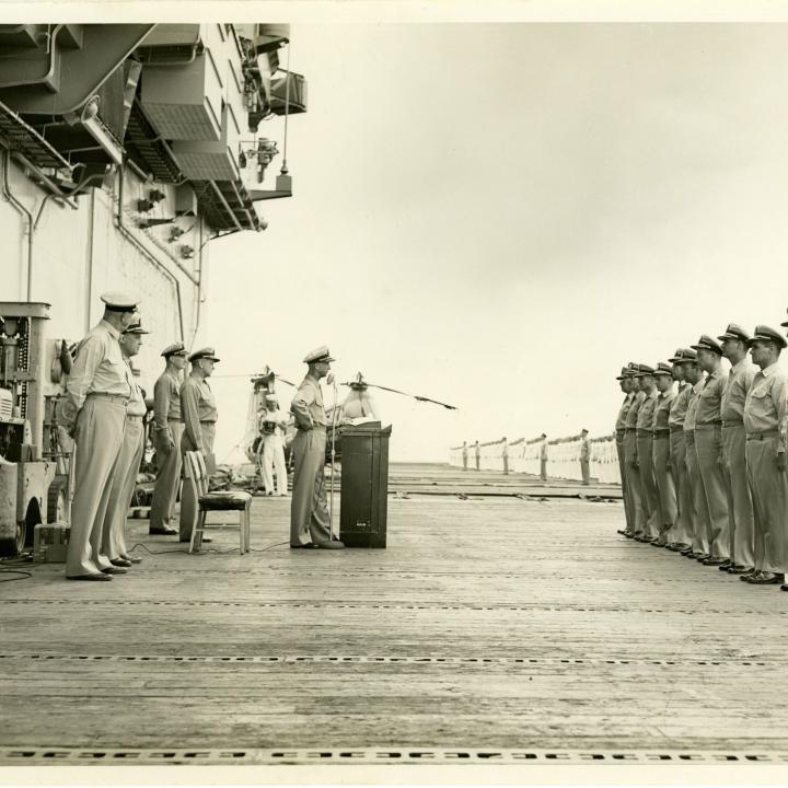 Primary Image of Captain Arnold McKechnie Addressing the Crew of the USS Yorktown (CVA-10)