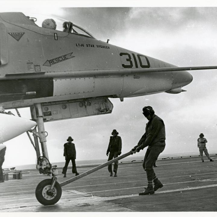 Primary Image of A-4 Skyhawk Being Moved Across the Flightdeck