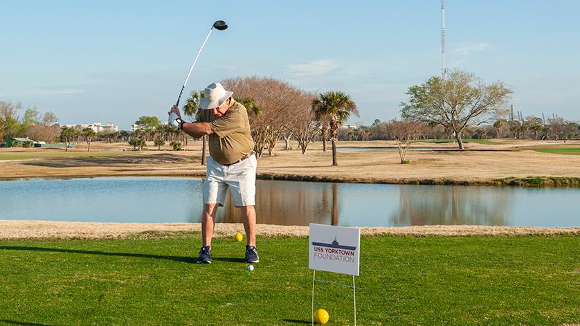 A player swinging a golf club at the golf tournament