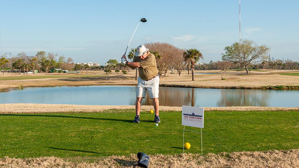 A player swinging a golf club at the golf tournament