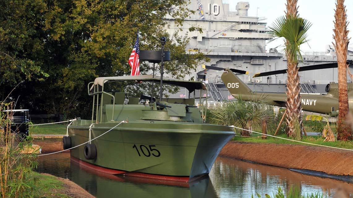 image of a vietnam era river boat sits in water