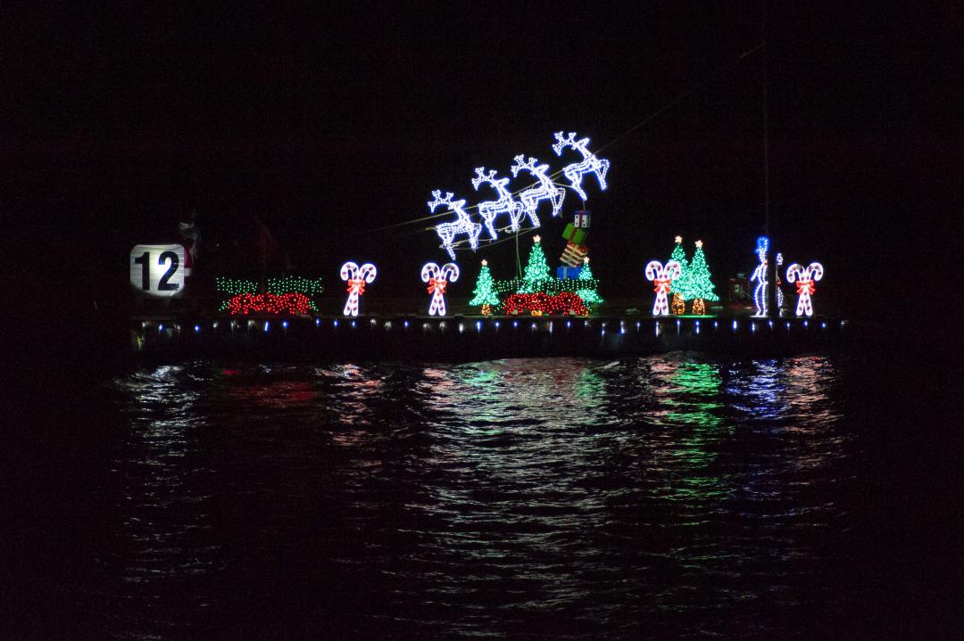Lights on the Harbor: A Boat Parade Watch Party showing a boat with lit up holiday decorations