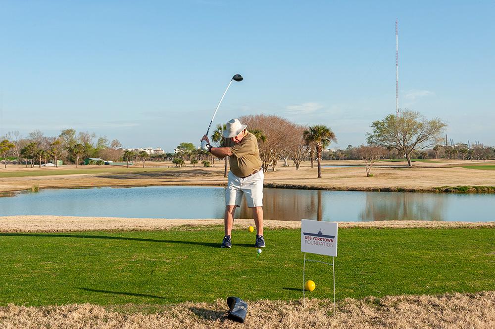 A player swinging a golf club at the golf tournament
