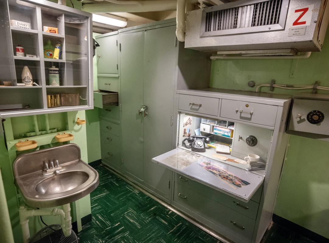 officer bathroom sink and vanity next to desk area