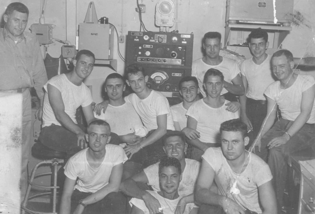 Black and white photograph of the aerology crew in the weather office aboard USS YORKTOWN during Korea.