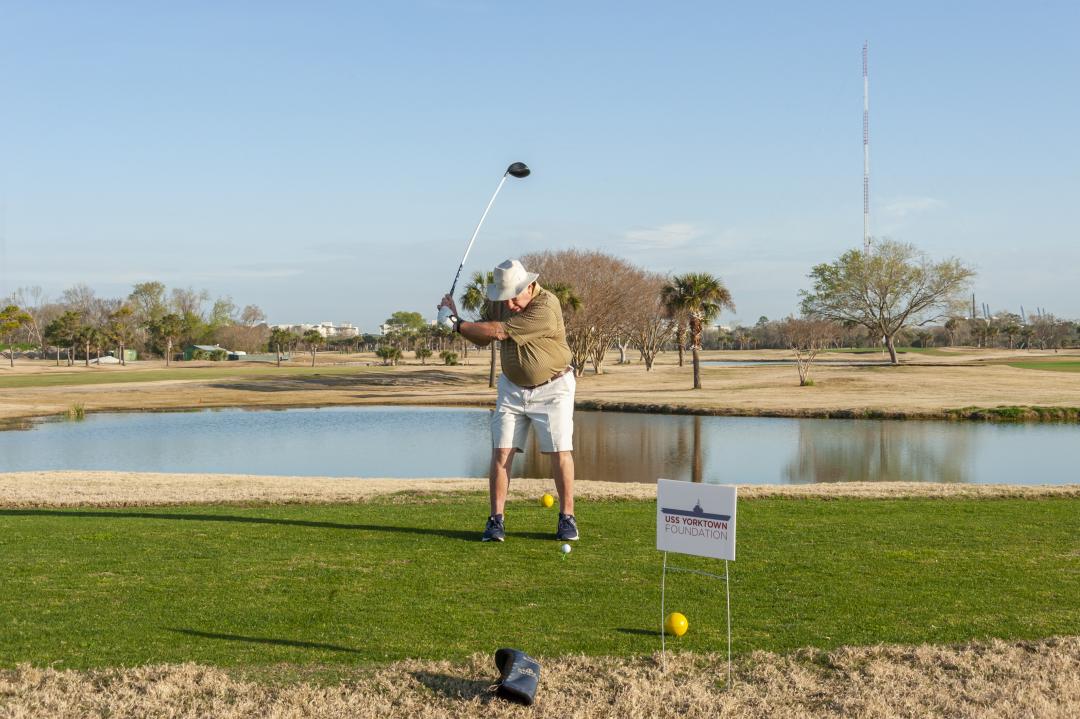 A man plays golf for the Holes Fore Heroes tournament.