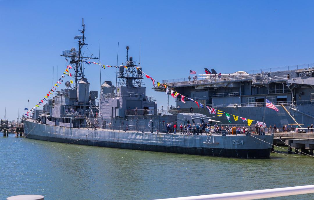 The USS Laffey decorated with flags and guests.