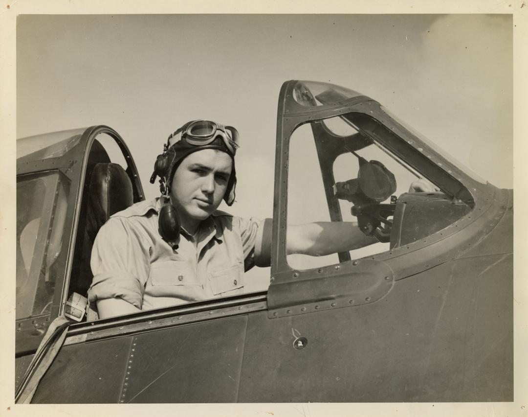 Image of Smokey Stover sitting in the cockpit of an aircraft.