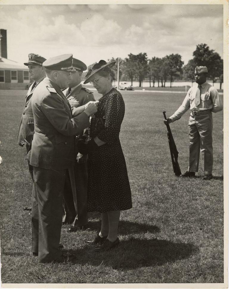 Stella Stover, Smokey Stover's mother, stands ready to receive an award from the American military.