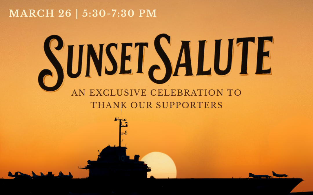 Naval aircraft carrier with sunset backdrop.